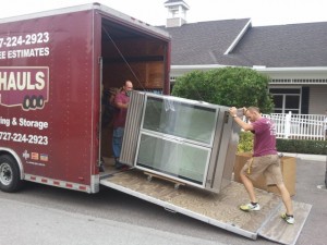 Loading a heavy large item into the moving trailer